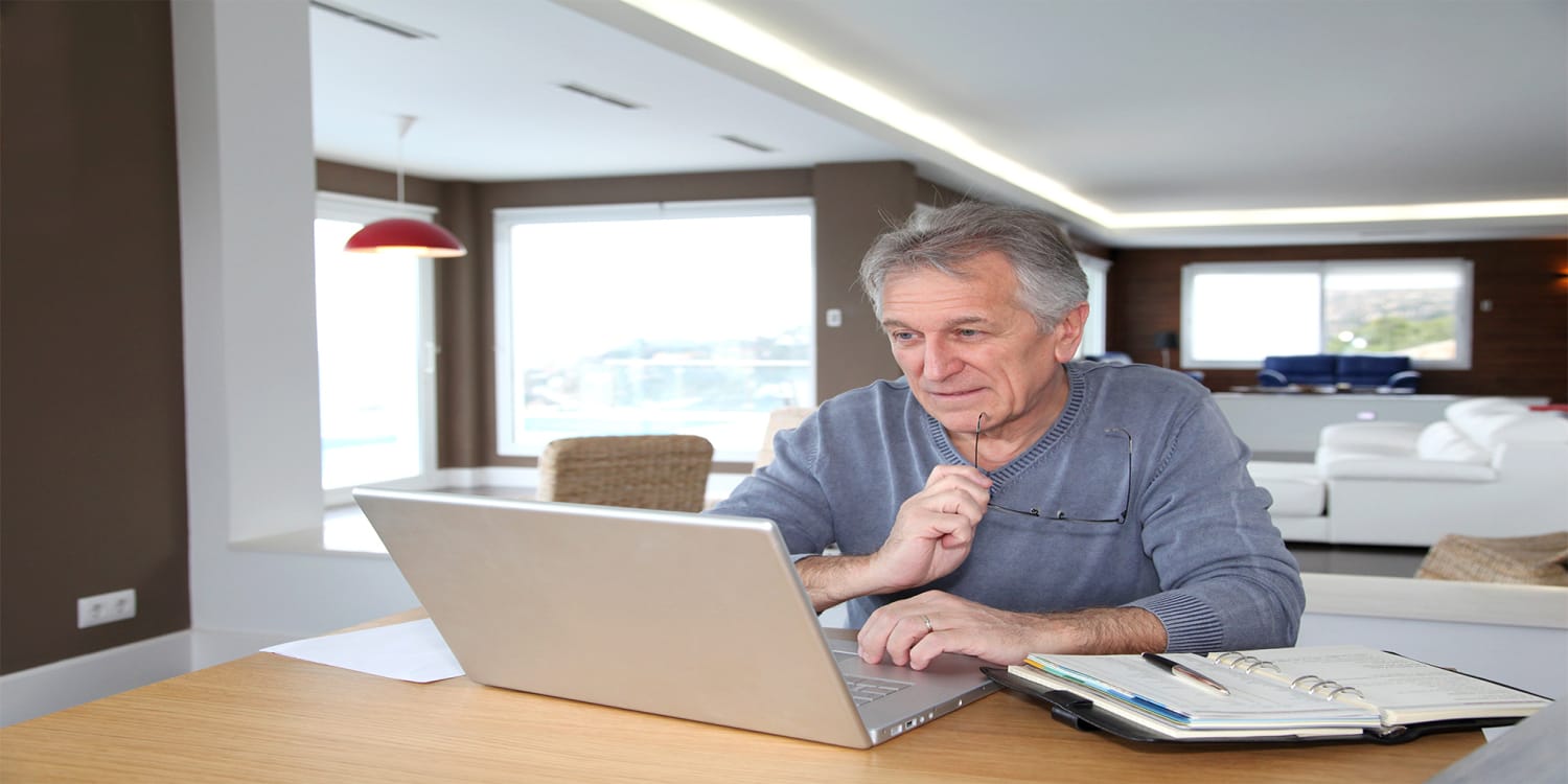 Man looking at computer, getting cash offer from PropertyLark